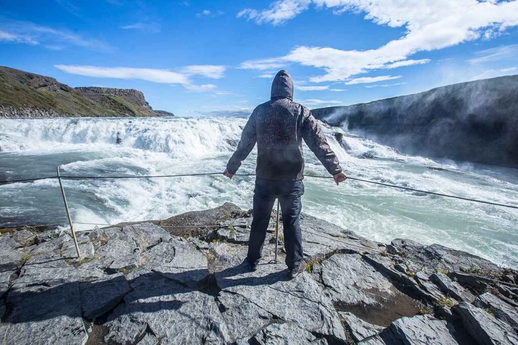 photodune-m2kRwtUd-a-young-man-above-the-gullfoss-waterfall-in-the-golden-circle-of-the-south-of-iceland-xl